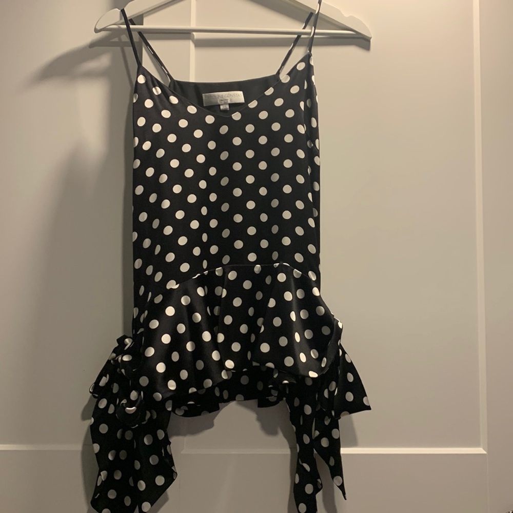 Feminine and fun black tank top with white polka dots. Luxurious silk texture
